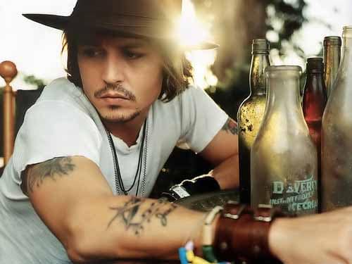 johnny depp wearing leather bracelets showing his tattoos