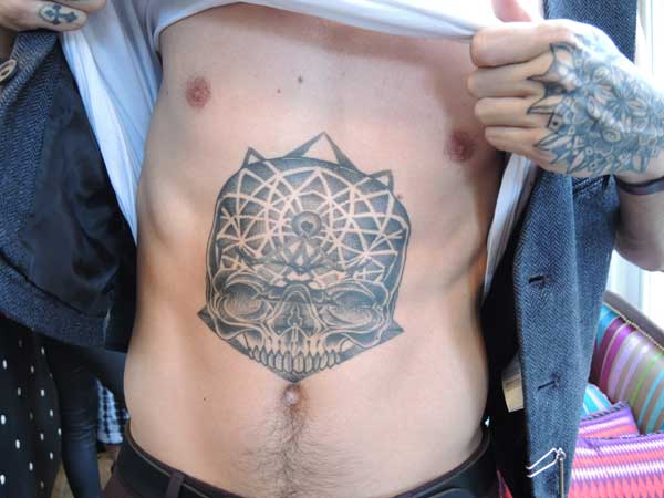 Tattoo of a skull on a man's stomach
