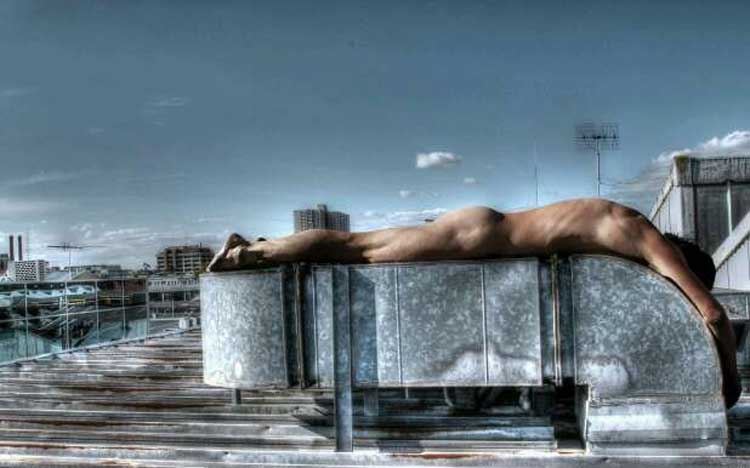Naked man on a roof top