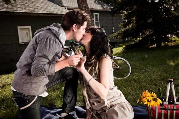man proposing at a picnic