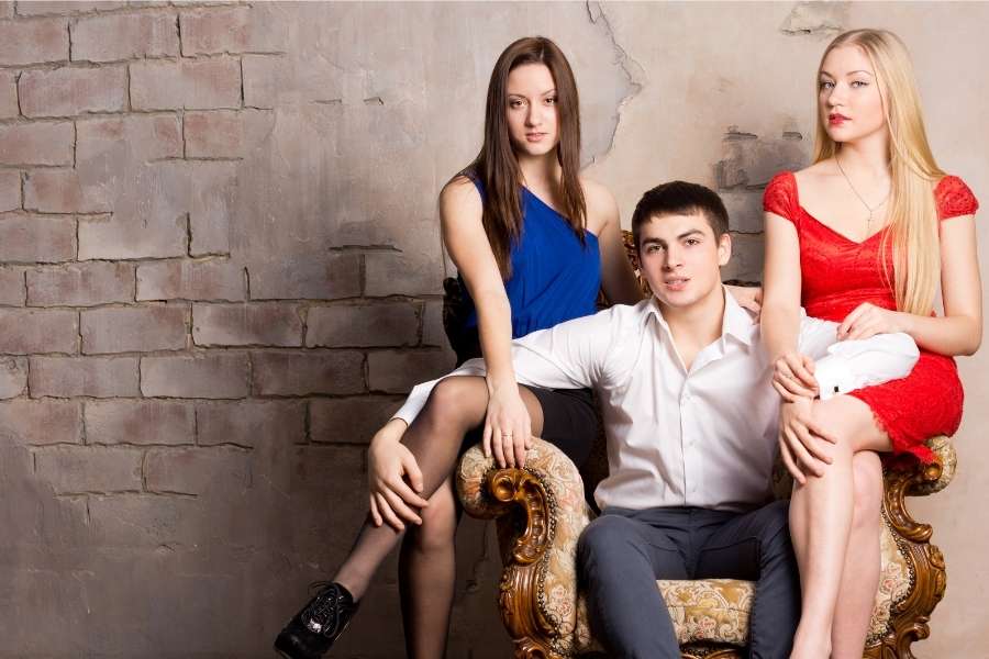 man posing with other women