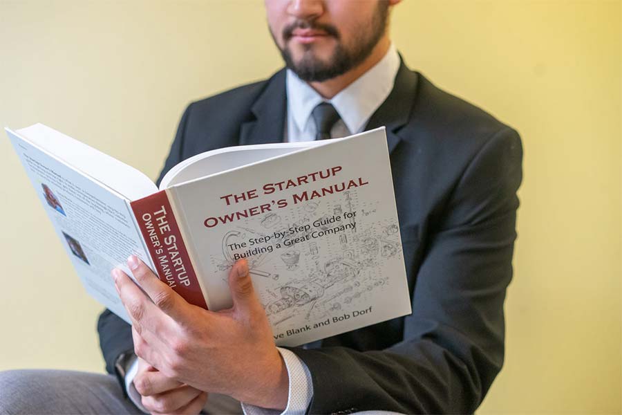 man reading book about self improvement