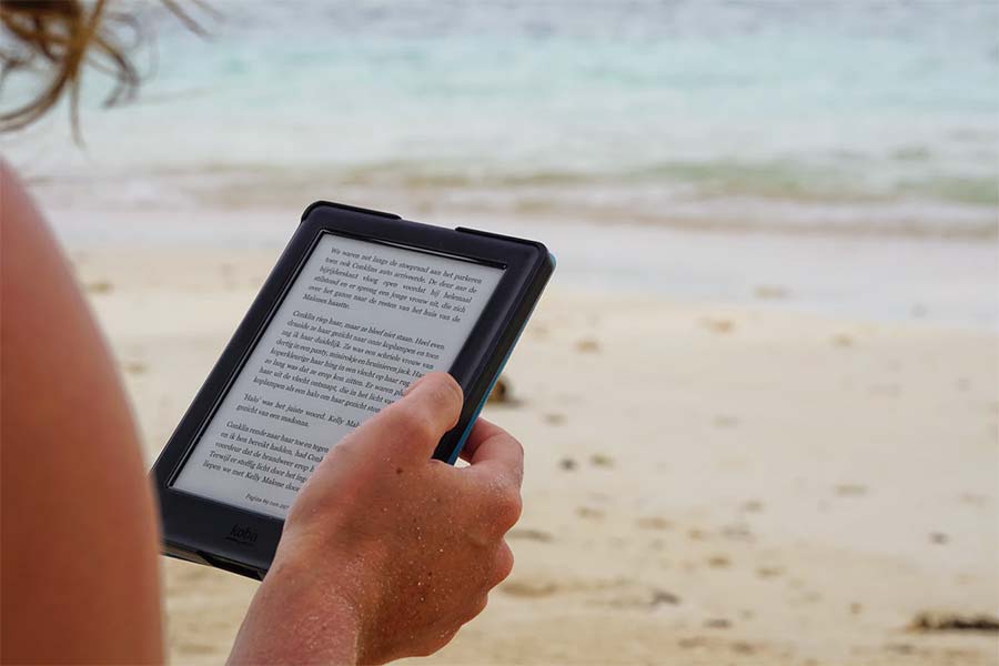 reading the kindle on the beach